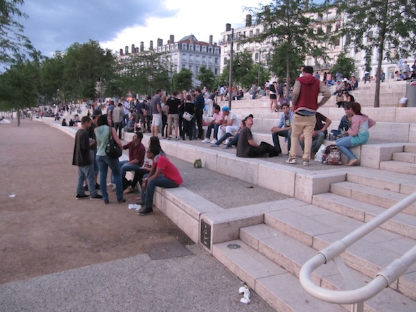 People sitting on the embankment - Fête de la Musique