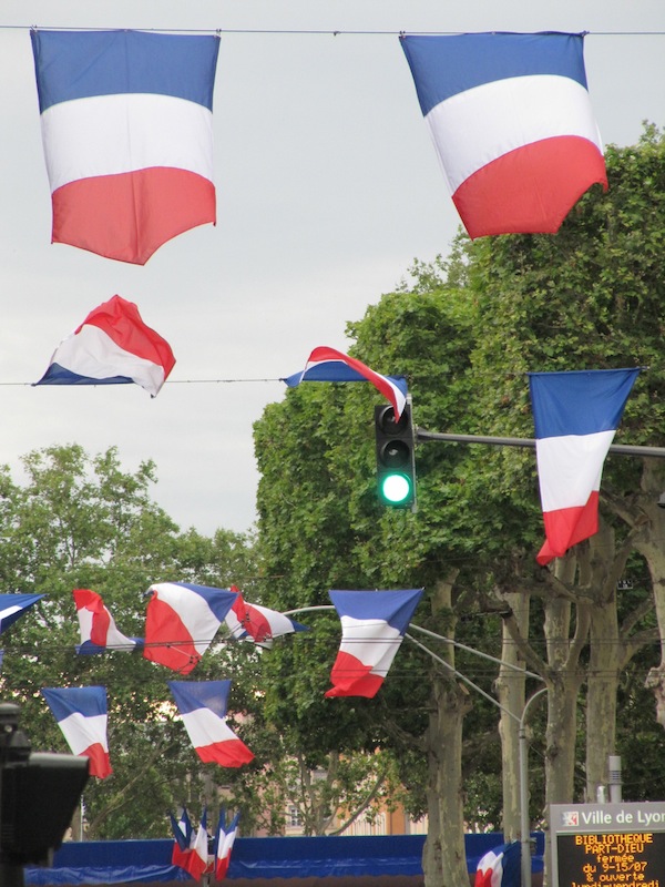 French flags fluttering overhead