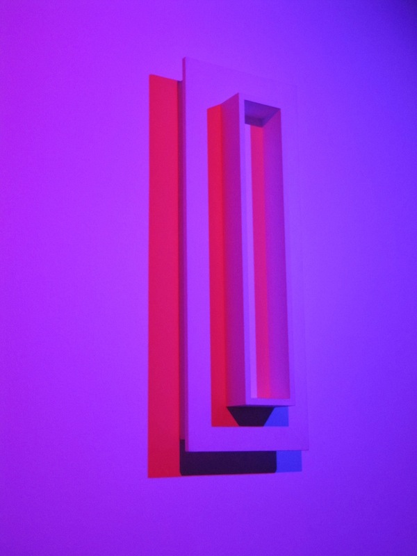 Extruded boxes bathed in red and blue lights.