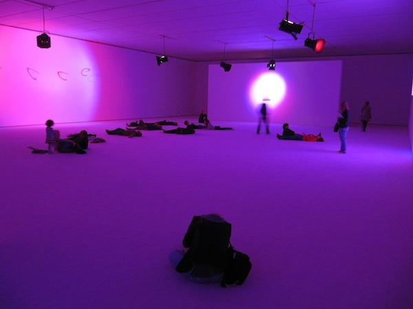 Visitors lay on the floor surrounded by noise.