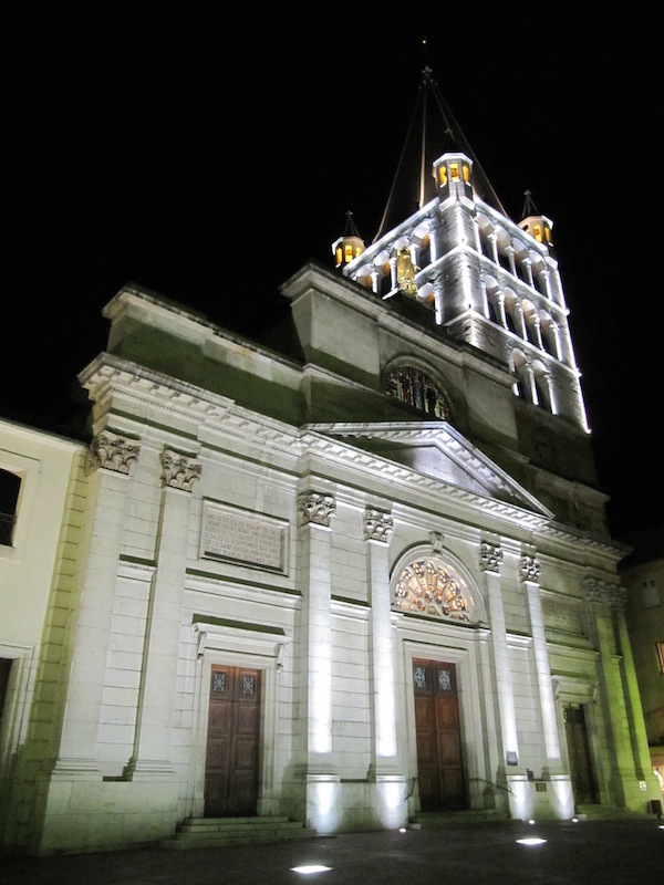 The church is lit at night.