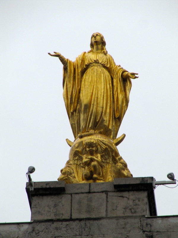 The lady in question, in gold, adorns the top of the church.
