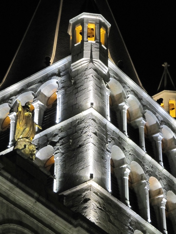 The church&rsquo;s tower lit up at night.