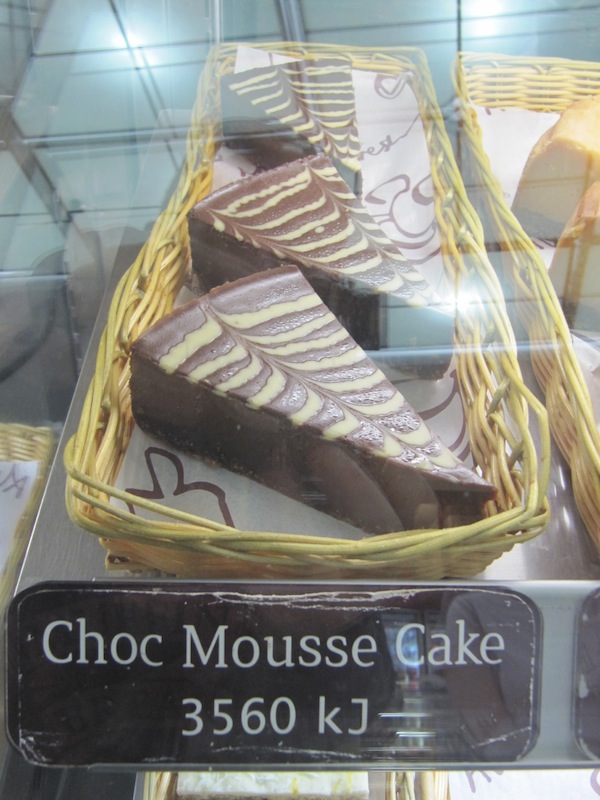 Muffin Break Choc Mousse Cake and calorie count behind glass