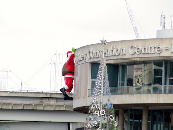 Darling Harbour - Father Christmas hangs onto the Convention Centre