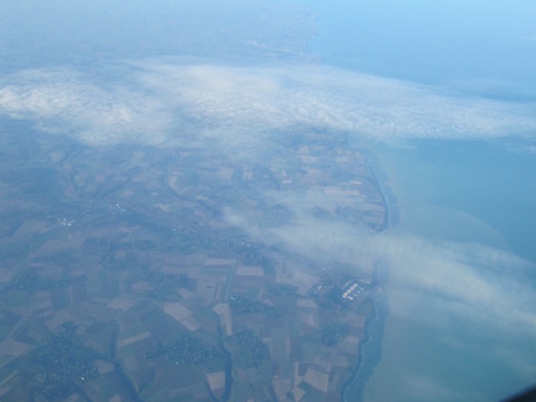 The coast line of France appears far below.