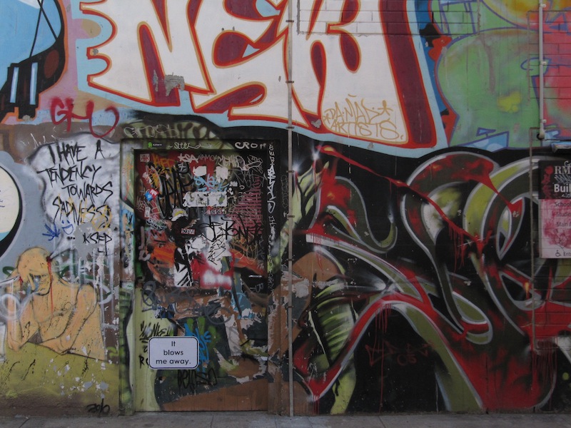 A doorway hidden among the graffiti