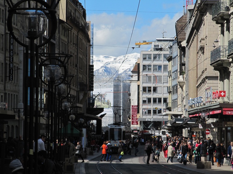 Mountains complete the view down a Geneva shopping street
