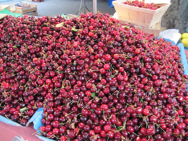 Cherries piled high on a market stall