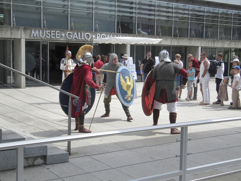 Actors recreate scenes of Roman training for the queuing visitors
