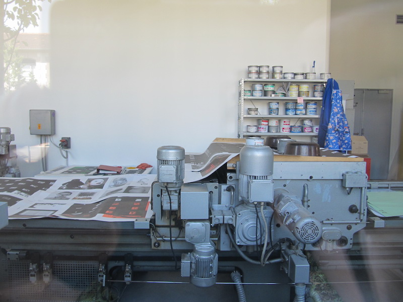 Peering inside the windows reveals printing equipment
