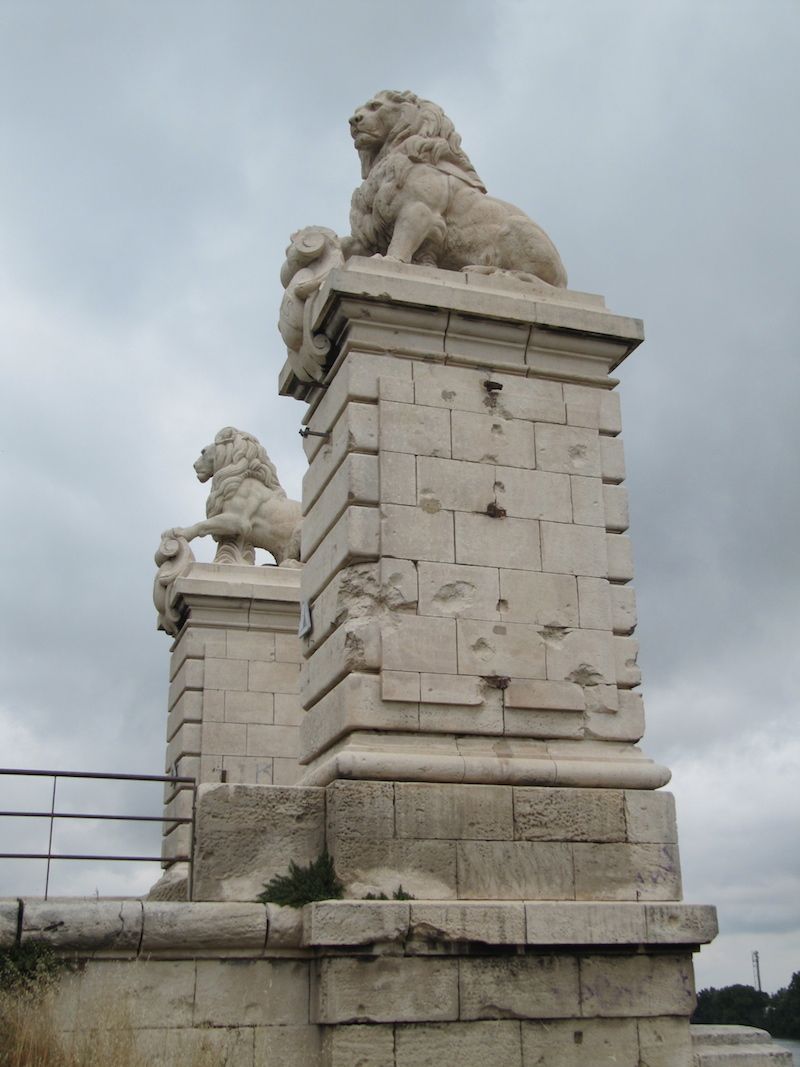 Lions top pillars of an incomplete bridge