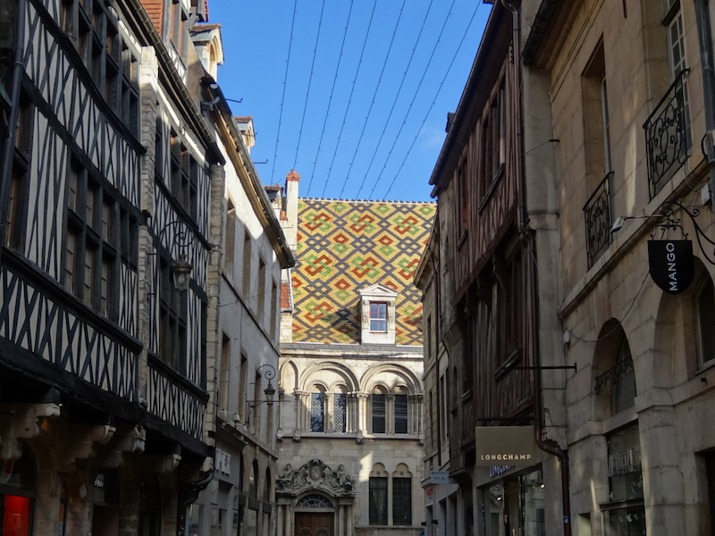 Patterned roof tiles visible down a Dijon street