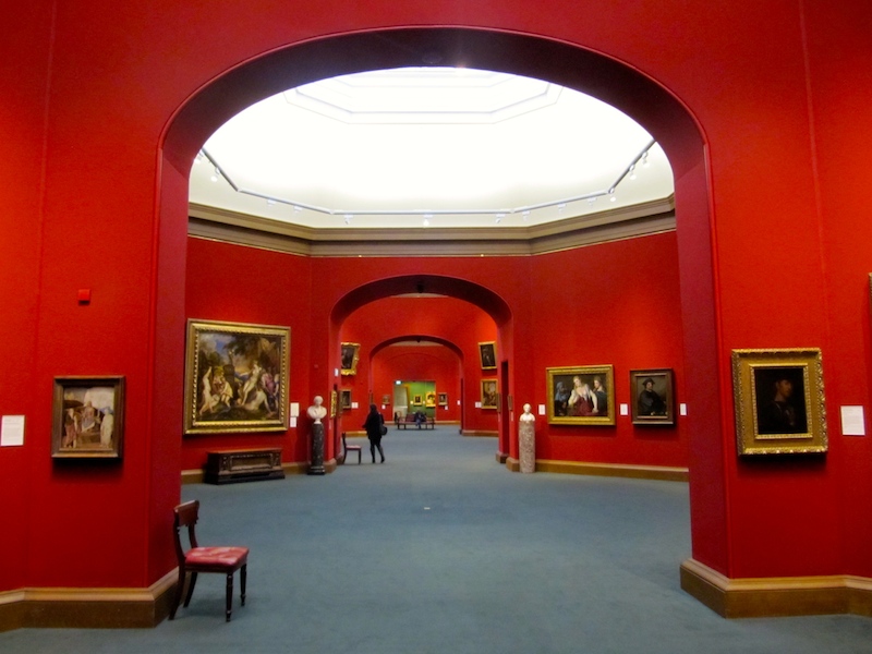 Crimson adorns the walls of the lower gallery