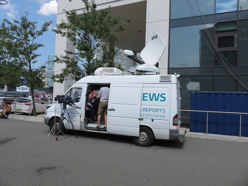 A television van waits for The Giants to appear