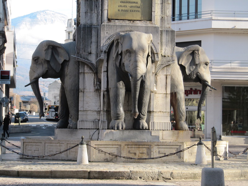 Elephants at the base of a monument
