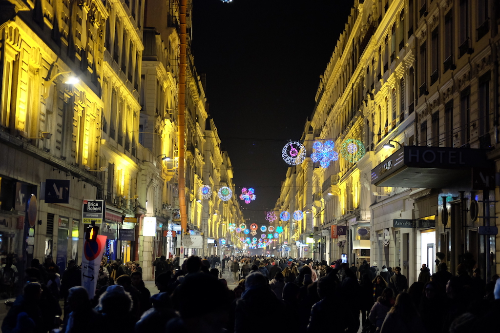 Crowds fill the streets of Lyon during the Fête des Lumières.