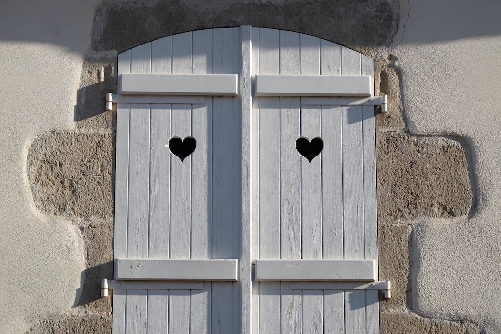 Hearts carved into window shutters.