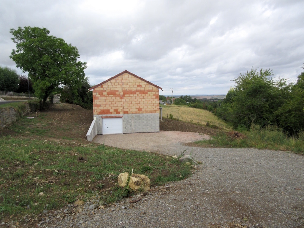 Build week 28: The land freshly graded all around the house