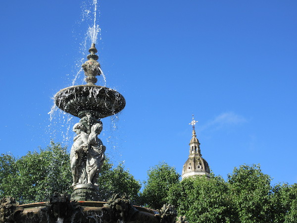 Fountain with church spire in the distance